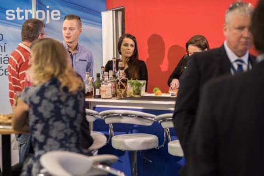 Colleagues having a drink attending the Amper event at the convention trade center in Brno. BVV Brno Exhibition center. Czech Republic