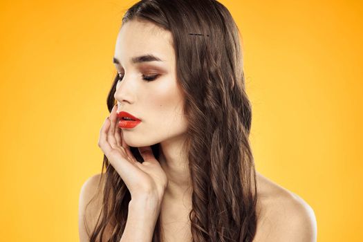 Woman with bare shoulders red cropped lips charm yellow background. High quality photo