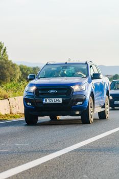 Traveling cars in motion on asphalt road, front view of cars in row on street. Bucharest, Romania, 2020