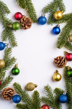 Christmas composition. Colorful ball ornament, pine cones and fir needles decorations. Copy space