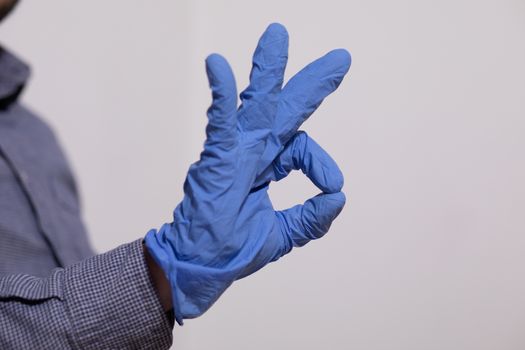 Man showing OK gesture - Everything is just fine in Gloves Stock Photo