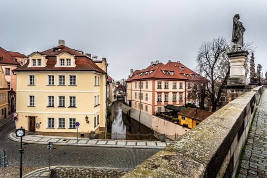 Autumn dawn in historic Prague at Charles Bridge over the Vltava River. Prague, ENESCO monument, Czech Republic