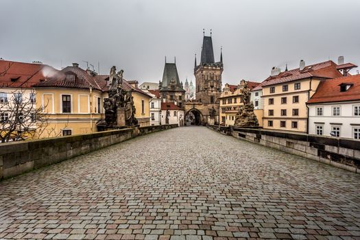 Autumn dawn in historic Prague at Charles Bridge over the Vltava River. Prague, ENESCO monument, Czech Republic