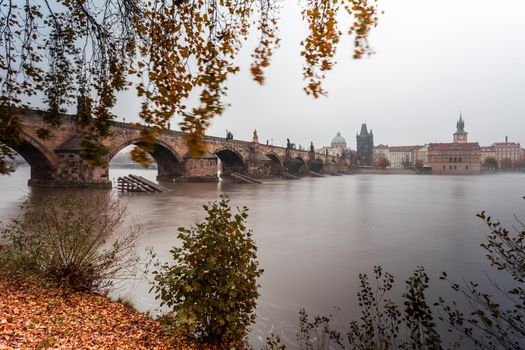 Autumn dawn in historic Prague at Charles Bridge over the Vltava River. Prague, ENESCO monument, Czech Republic