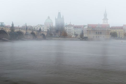 Autumn dawn in historic Prague at Charles Bridge over the Vltava River. Prague, ENESCO monument, Czech Republic