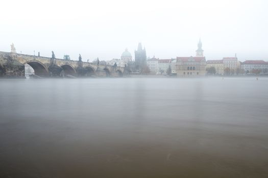 Autumn dawn in historic Prague at Charles Bridge over the Vltava River. Prague, ENESCO monument, Czech Republic