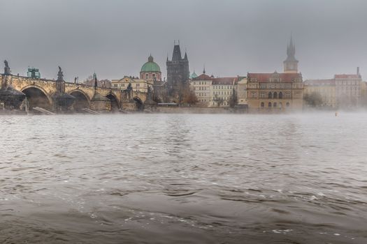 Autumn dawn in historic Prague at Charles Bridge over the Vltava River. Prague, ENESCO monument, Czech Republic