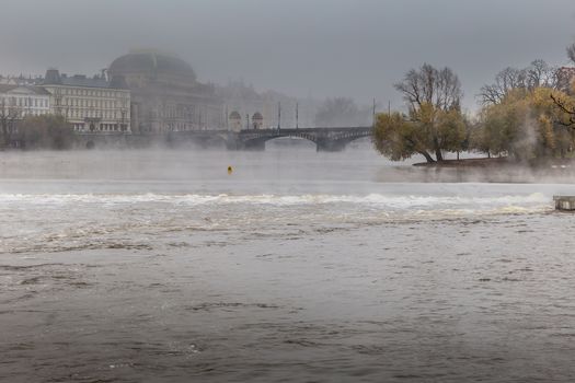 Autumn dawn in historic Prague at Charles Bridge over the Vltava River. Prague, ENESCO monument, Czech Republic