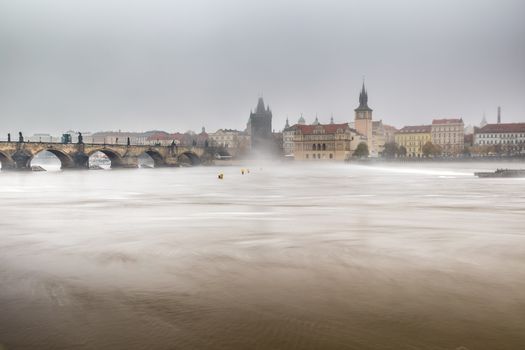 Autumn dawn in historic Prague at Charles Bridge over the Vltava River. Prague, ENESCO monument, Czech Republic