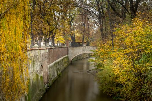 Autumn dawn in historic Prague at Charles Bridge over the Vltava River. Prague, ENESCO monument, Czech Republic