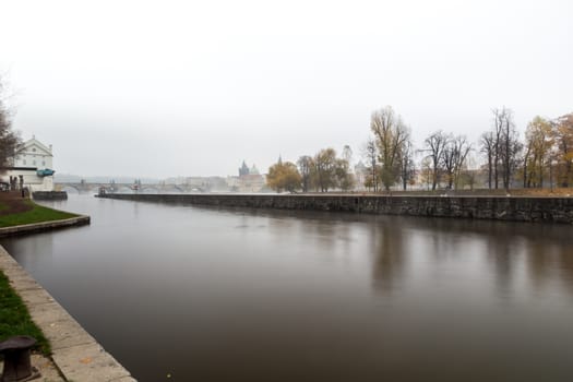 Autumn dawn in historic Prague at Charles Bridge over the Vltava River. Prague, ENESCO monument, Czech Republic