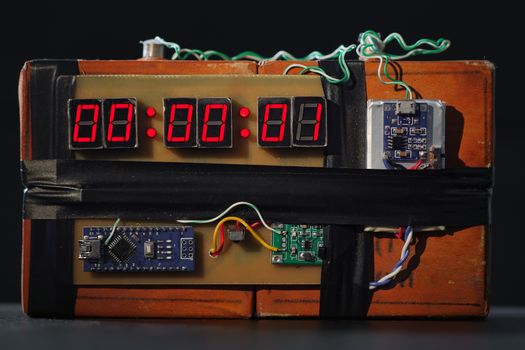 Time Bomb is Going to Explode or Detonate per 1 Second. Terrorist Threat. Dynamite with Clockwork. Explosives with Detonator. Bomb with Red Timer on Black Background. Improvised Explosive Device. TNT