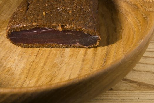 Piece of smoked meat on wooden board