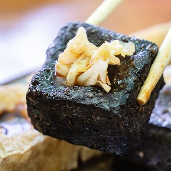 Deep fried stinky tofu, fermented bean curd with pickled cabbage vegetable, famous and delicious street food in Taiwan, lifestyle.