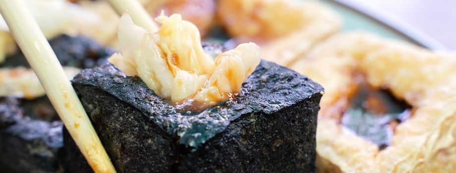 Deep fried stinky tofu, fermented bean curd with pickled cabbage vegetable, famous and delicious street food in Taiwan, lifestyle.