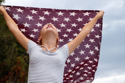 teenage girl with a handkerchief fluttering in the wind in her hands,