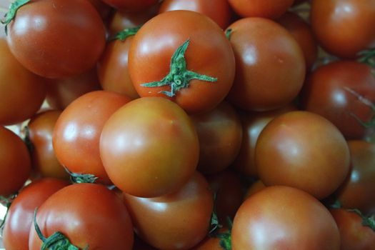 Close-up view of red tomatoes in market for sale. A fruit background for text and advertisements