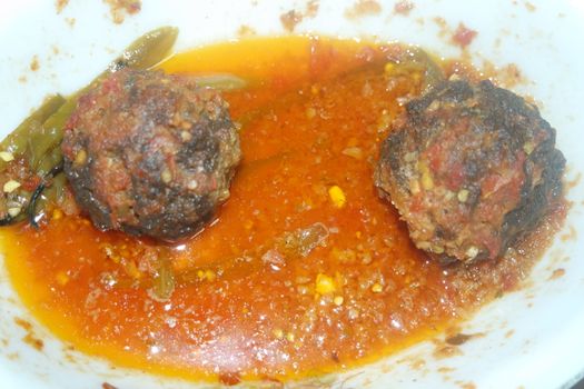 Closeup view with selective focus of meatball dish.Top view of meat balls or meat kofta curry in masala gravy in a ceramic plate.