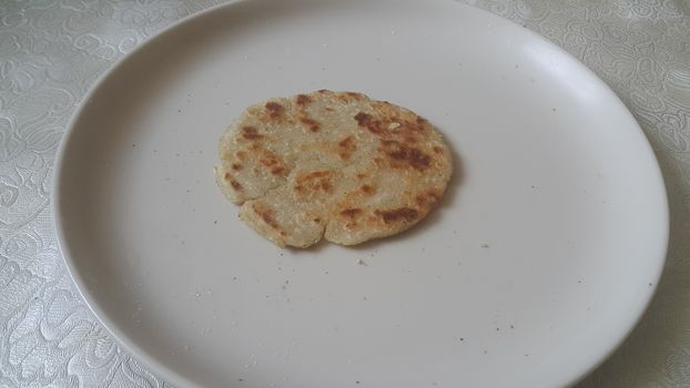 Closeup view of of traditional bread called Jawar roti or bhakri on white background. Bhakri is a round flat unleavened bread often used in the cuisine of many Asian countries