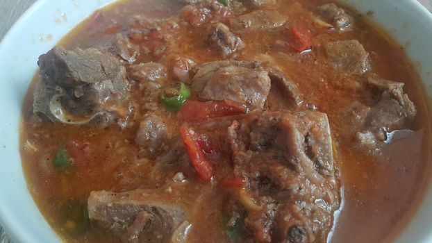 A close up view of stewed chicken meat cubes with spices on it, a traditional home made delicious chicken meat dish