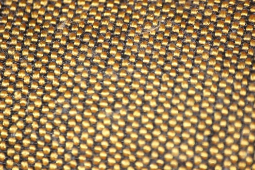 macro photo as background close up of golden color cloth fibers knitted and woven