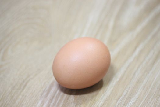 Closeup selective view of fresh farm chicken eggs isolated on a wooden background