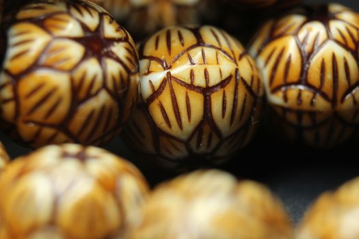 Beautiful wooden prayer beads or rosary with a striped background. Religion concept of ramadan or Eid for muslims.