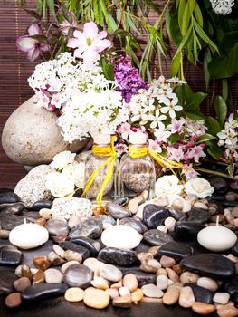 Aromatherapy, spa, beauty treatment and wellness background with massage stone, flowers, burning candles... spa concept