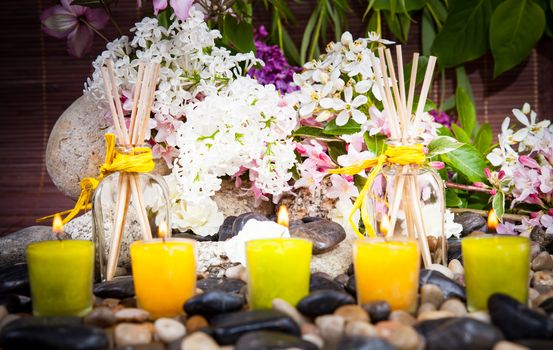 Aromatherapy, spa, beauty treatment and wellness background with massage stone, flowers, burning candles... spa concept