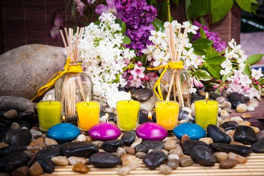 Aromatherapy, spa, beauty treatment and wellness background with massage stone, flowers, burning candles... spa concept