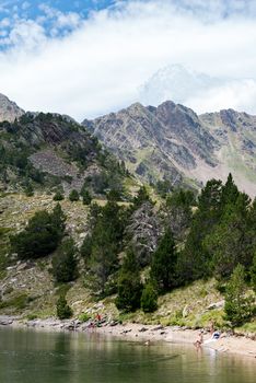 Coma Pedrosa, Andorra : 02 August 2020 : 
Group of tourists resting at Lago de les Truites in Andorra Pyrenees in summer 2020.