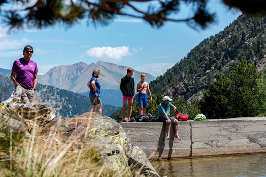 Coma Pedrosa, Andorra : 02 August 2020 : 
Group of tourists resting at Lago de les Truites in Andorra Pyrenees in summer 2020.