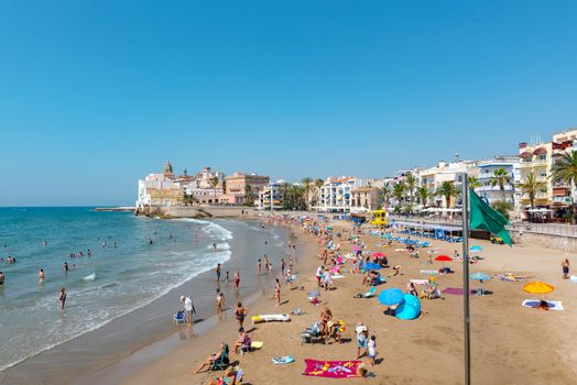 Sitges, Catalonia, Spain: July 28, 2020: People in the beach in Sitges in summer 2020.