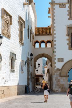 Sitges, Catalonia, Spain: July 28, 2020: People walking in the old town in Sitges in summer 2020. walking on the beach in Sitges in summer 2020.