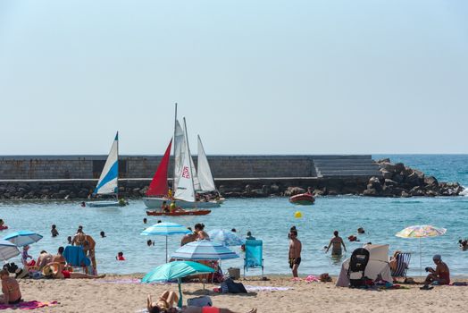 Sitges, Catalonia, Spain: July 28, 2020: People in the beach in Sitges in summer 2020.