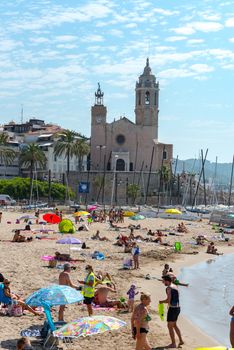 Sitges, Catalonia, Spain: July 28, 2020: People in the beach in Sitges in summer 2020.