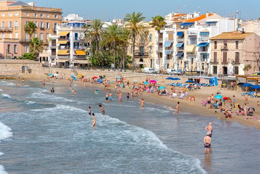 Sitges, Catalonia, Spain: July 28, 2020: People in the beach in Sitges in summer 2020.