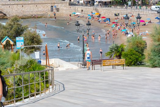 Sitges, Catalonia, Spain: July 28, 2020: People in the beach in Sitges in summer 2020.