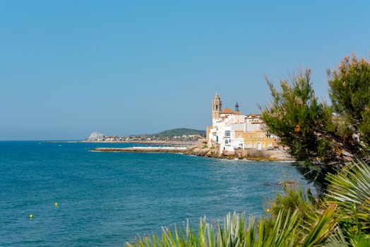 Sandy beach and historic old town in the Mediterranean complex Sitges near Barcelona, ​​Costa Dorada, Catalonia, Spain