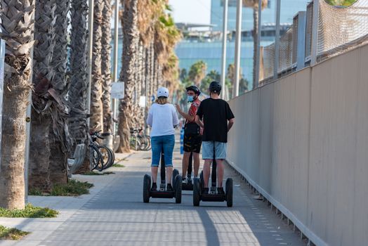 Barcelona, Spain - July 28 2020:  People walking through empty streets after COVID 19 LA Barceloneta in Barcelona, Spain.