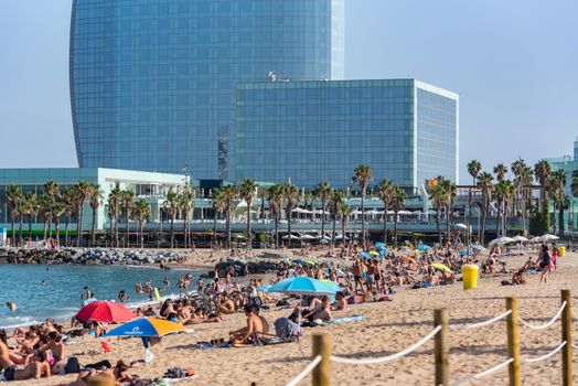 Barcelona, Spain - July 28 2020:  People in the Barceloneta Beach after COVID 19 La Barceloneta in Barcelona, Spain.