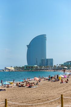 Barcelona, Spain - July 28 2020:  People in the Barceloneta Beach after COVID 19 La Barceloneta in Barcelona, Spain.