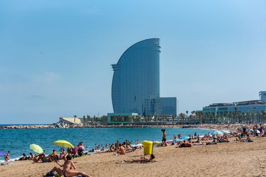 Barcelona, Spain - July 28 2020:  People in the Barceloneta Beach after COVID 19 La Barceloneta in Barcelona, Spain.