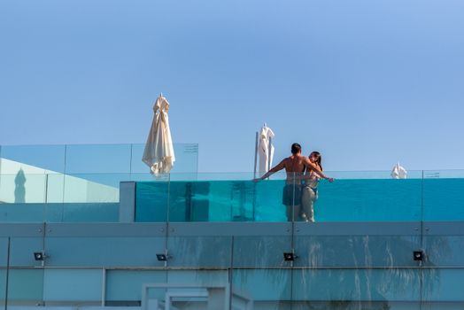 Barcelona, Spain - July 28 2020:  Couple in the swiming pool after COVID 19 La Barceloneta in Barcelona, Spain.