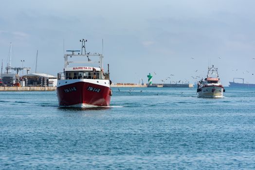 Barcelona, Spain - July 28 2020:  Ships in the  Barcelona Port through empty streets after COVID 19 in Barcelona, Spain.