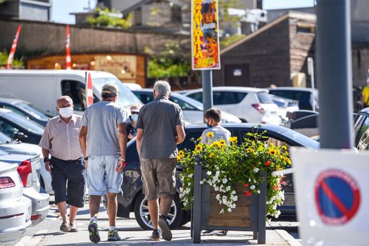 Les Angles, France : 2020 July 19 : People walk in summer on Les Angles ski resort city in Sunny day.  les Angles, France.