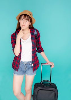 Beautiful portrait young asian woman thinking idea travel in vacation with luggage isolated on blue background, asia girl journey expression with cheerful and happy, holiday in summer concept.