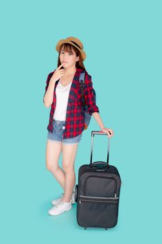 Beautiful portrait young asian woman thinking idea travel in vacation with luggage isolated on blue background, asia girl journey expression with cheerful and happy, holiday in summer concept.