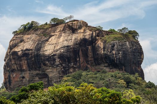 Sigiriya Rock Sri Lanka photographed from rear above forest with blue sky. High quality photo