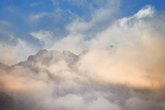 The colorful clouds above the summit of Mount Mars in the Biella pre-Alps